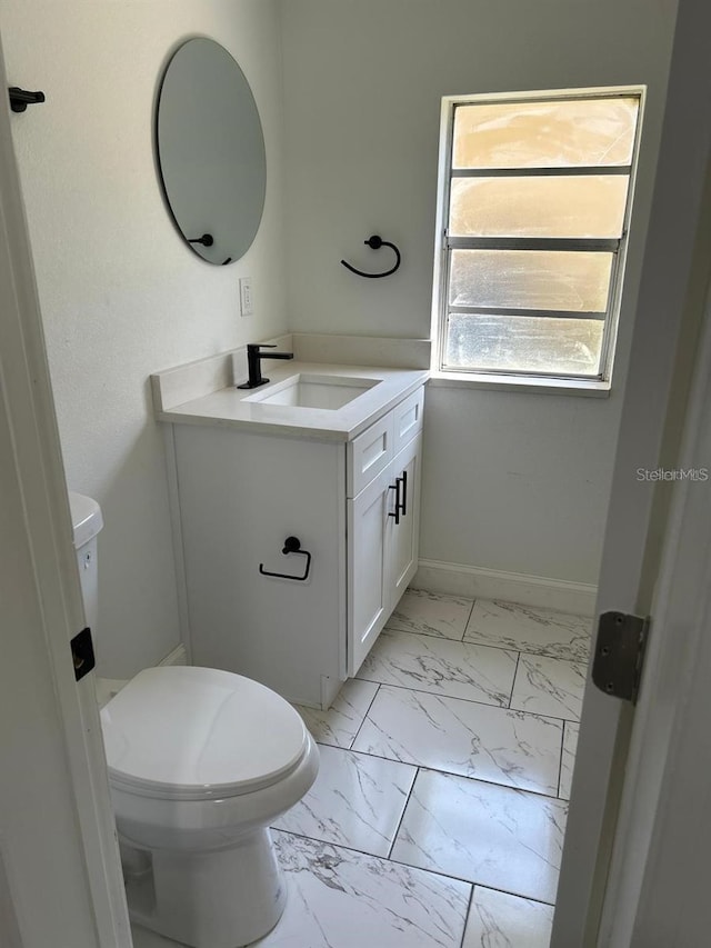 bathroom featuring vanity and toilet