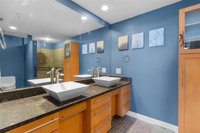 bathroom featuring tile patterned flooring, vanity, and toilet