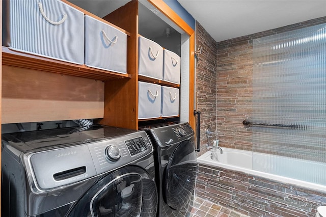 clothes washing area featuring separate washer and dryer