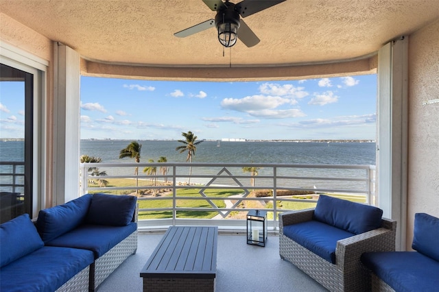 view of patio / terrace featuring an outdoor living space, a balcony, and a water view