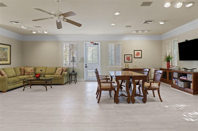 tiled dining space featuring ceiling fan and ornamental molding