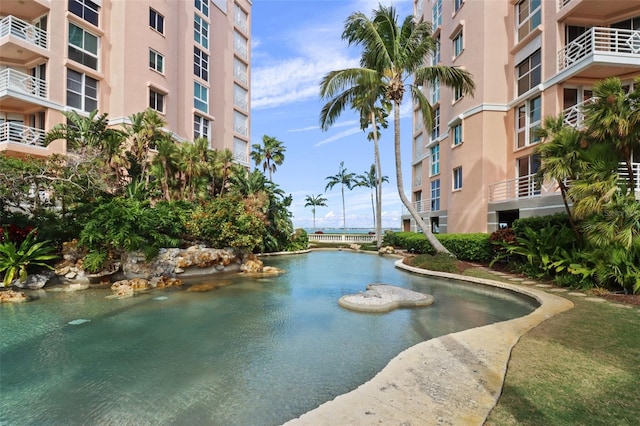 view of swimming pool featuring a water view