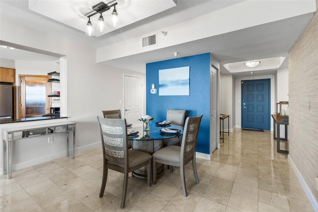 dining space featuring a textured ceiling