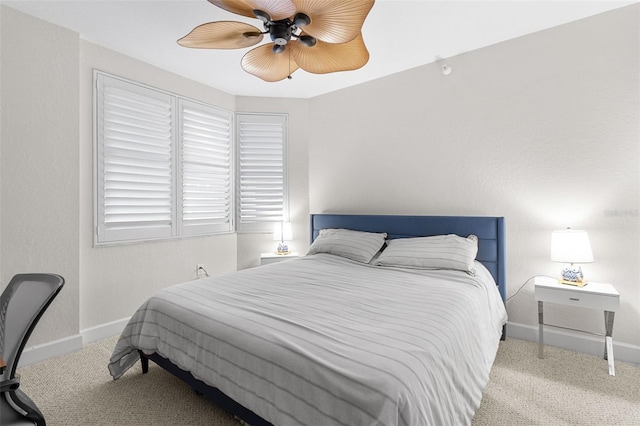 bedroom with light carpet and ceiling fan