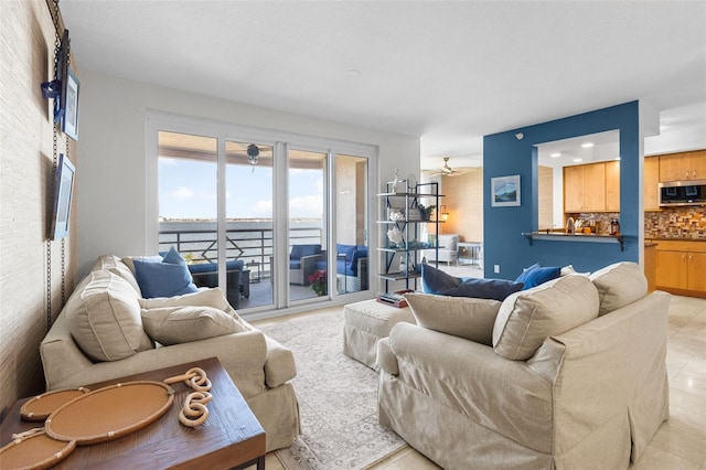 living room featuring light tile patterned floors and ceiling fan