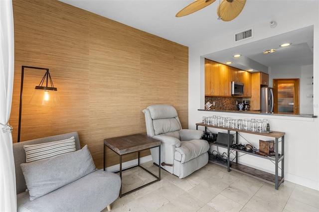 living area featuring ceiling fan