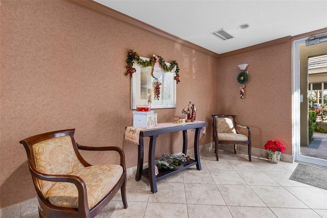 sitting room featuring ornamental molding and light tile patterned floors