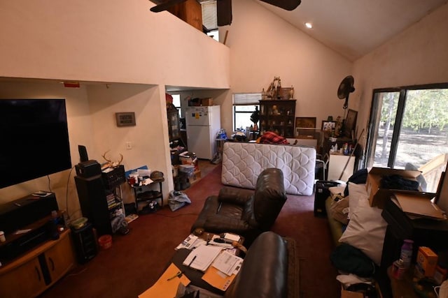 living room with carpet floors and high vaulted ceiling