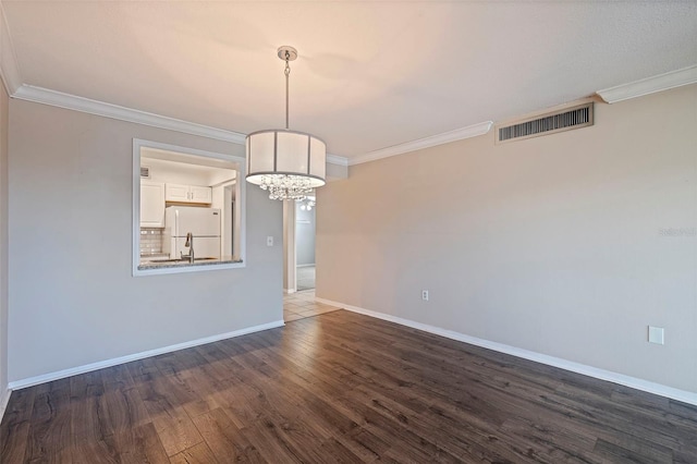 unfurnished dining area with sink, ornamental molding, and dark hardwood / wood-style floors