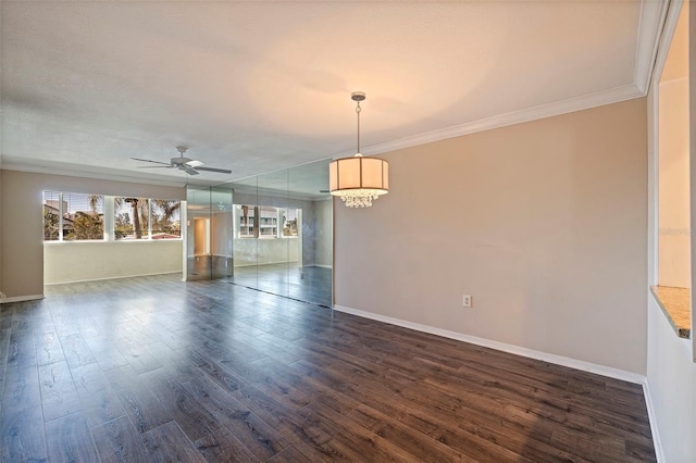 empty room featuring ceiling fan, dark wood-type flooring, and ornamental molding