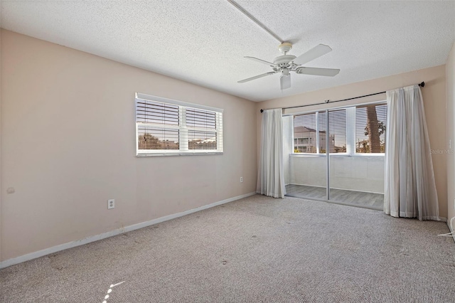 empty room with a textured ceiling, ceiling fan, and carpet floors