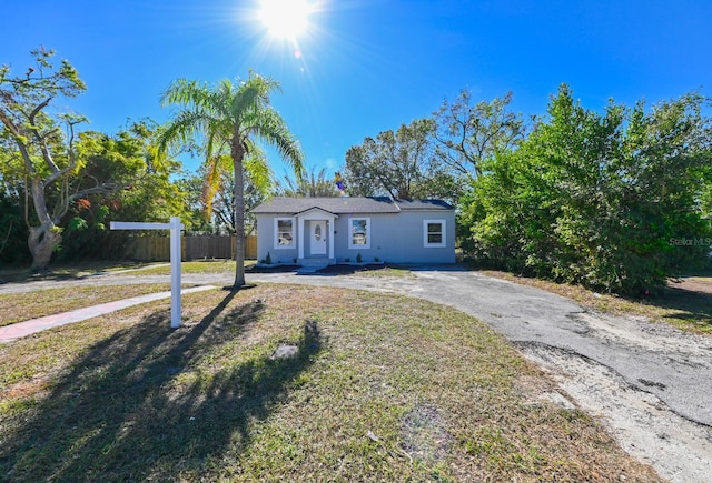 ranch-style home with a front lawn