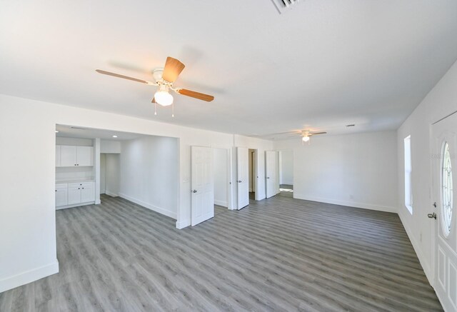 unfurnished living room featuring light wood-type flooring and ceiling fan