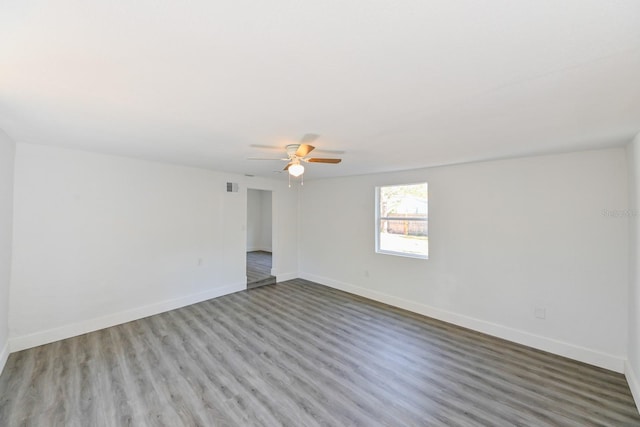 spare room featuring hardwood / wood-style flooring and ceiling fan