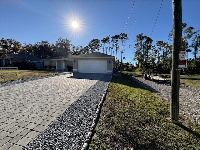 view of front of house with a front yard and a garage