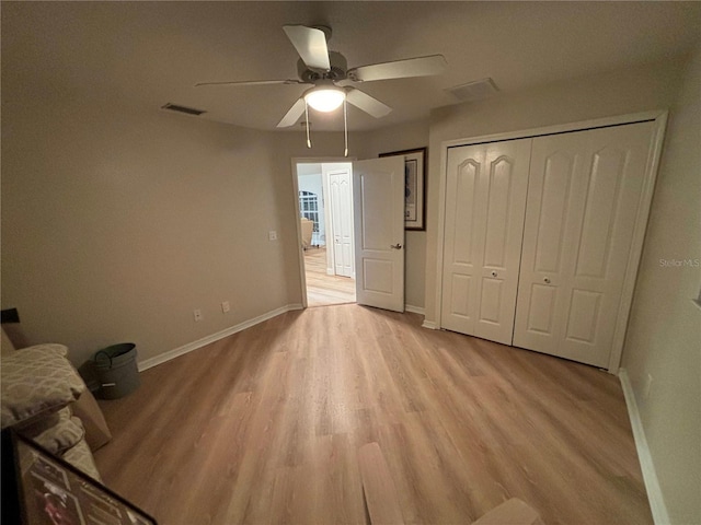 unfurnished bedroom with light hardwood / wood-style floors and ceiling fan