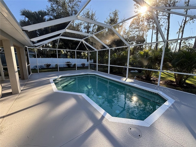 view of swimming pool with a patio and glass enclosure