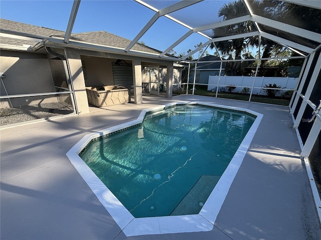 view of pool with a patio area and glass enclosure