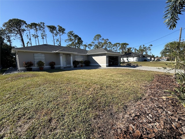 ranch-style house featuring a garage and a front yard