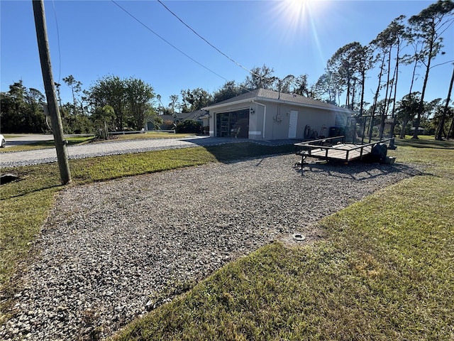 view of property exterior with a lawn and a garage