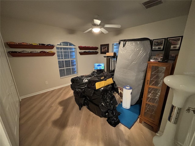 bedroom with hardwood / wood-style floors and ceiling fan