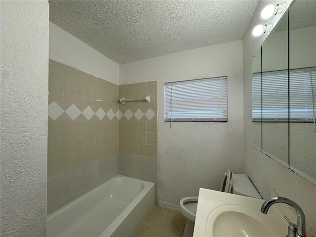 full bathroom featuring tile patterned floors, sink, a textured ceiling, and toilet