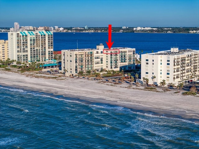 bird's eye view with a water view and a beach view