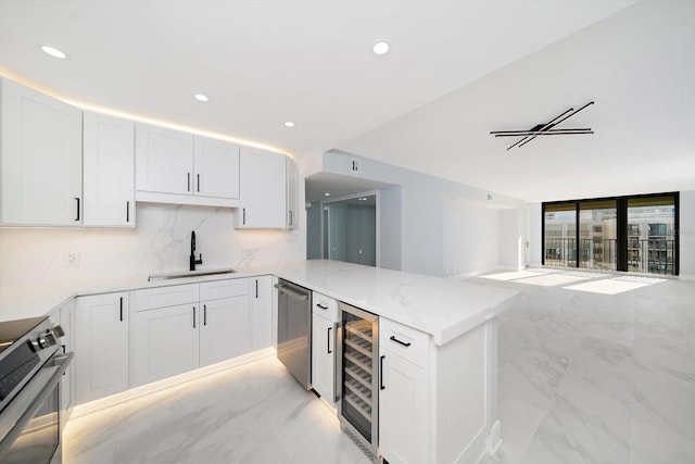 1400 Gulf Blvd Unit 801, Clearwater Beach, FL 33767 - kitchen featuring a sink, wine cooler, stainless steel appliances, light marble finish flooring, and recessed lighting