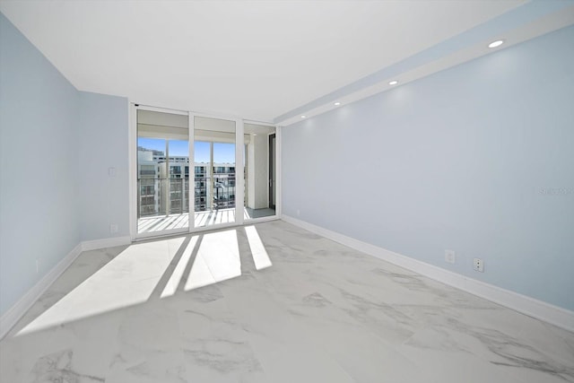 1400 Gulf Blvd Unit 801, Clearwater Beach, FL 33767 - empty room featuring marble look tiles, a wall of windows, baseboards, and recessed lighting