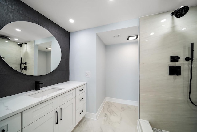 full bath with marble finish floors, tiled shower, baseboards, and recessed lighting