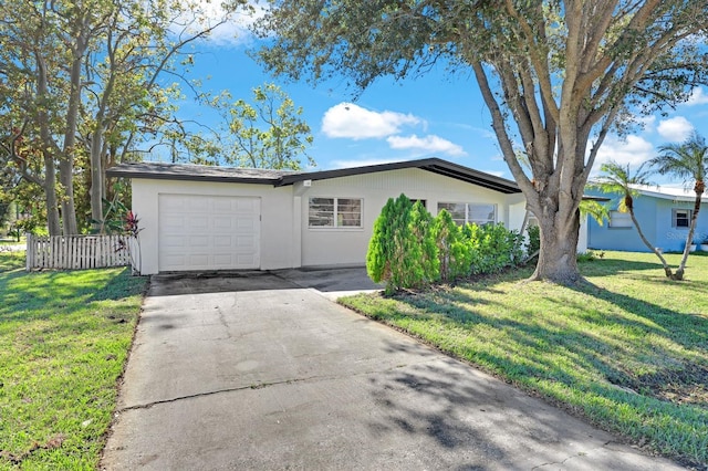 single story home with a front yard and a garage