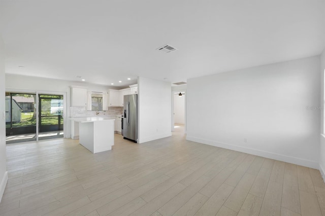 unfurnished living room with light wood-type flooring