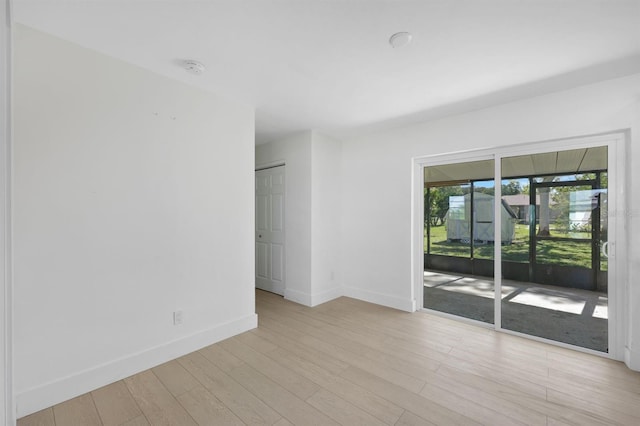 spare room with light wood-type flooring