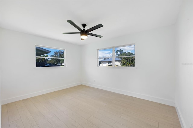 empty room with light wood-type flooring, plenty of natural light, and ceiling fan