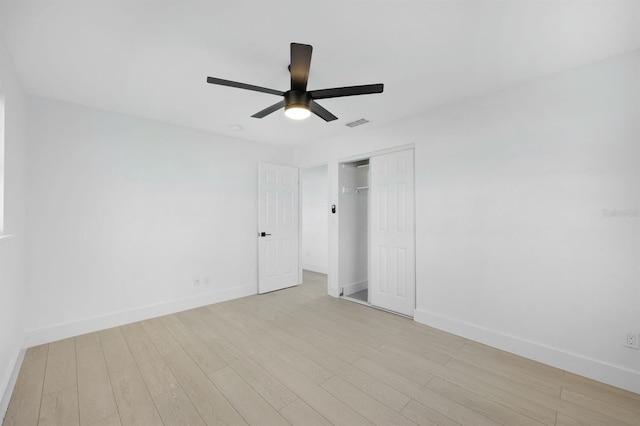 unfurnished bedroom featuring ceiling fan, light hardwood / wood-style floors, and a closet