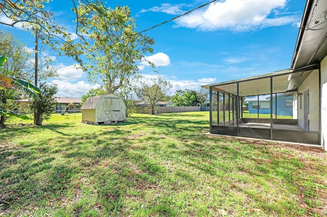 view of yard featuring a sunroom and a shed