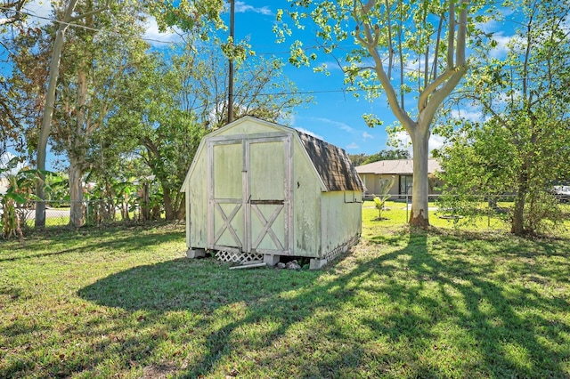 view of outdoor structure featuring a lawn