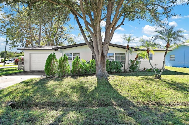 single story home with a garage and a front lawn