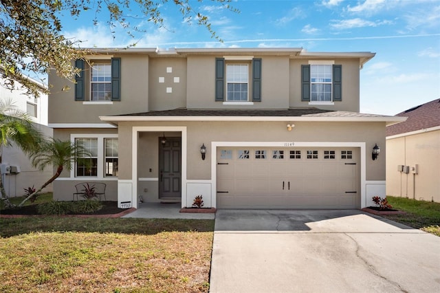 view of front of house featuring a garage and a front lawn