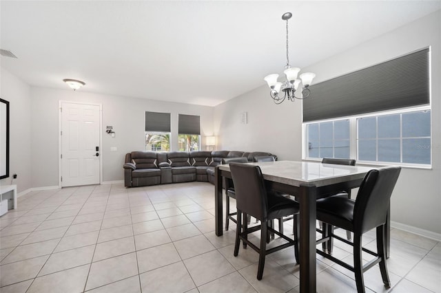 tiled dining area with an inviting chandelier