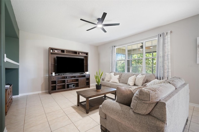 living room featuring a textured ceiling, ceiling fan, and light tile patterned flooring