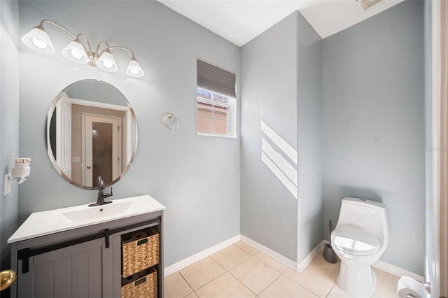 bathroom with tile patterned flooring, vanity, and toilet