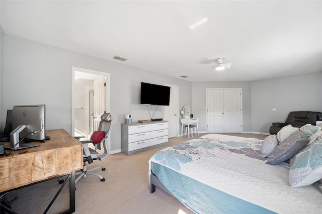 carpeted bedroom with ceiling fan and a closet