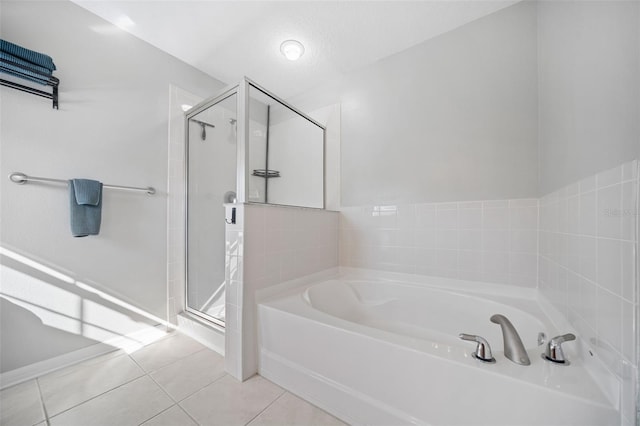 bathroom featuring plus walk in shower and tile patterned floors