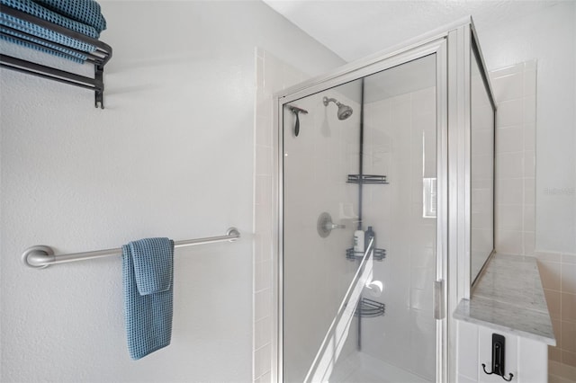 bathroom with a shower with door