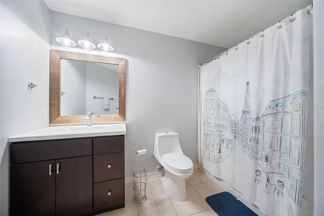 bathroom featuring toilet, vanity, and tile patterned floors