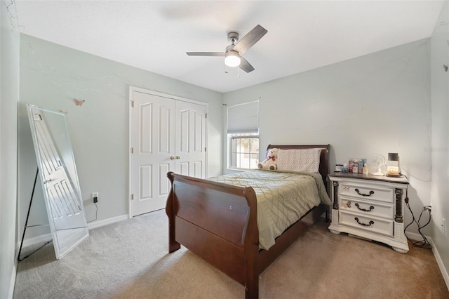 carpeted bedroom with ceiling fan and a closet