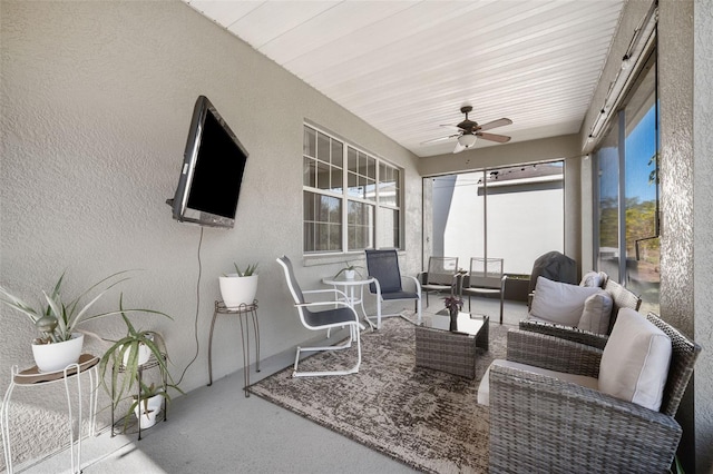 sunroom / solarium featuring plenty of natural light, wooden ceiling, and ceiling fan