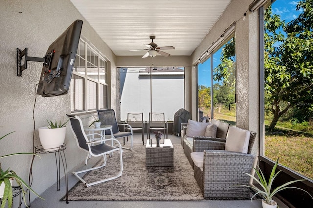 sunroom featuring ceiling fan