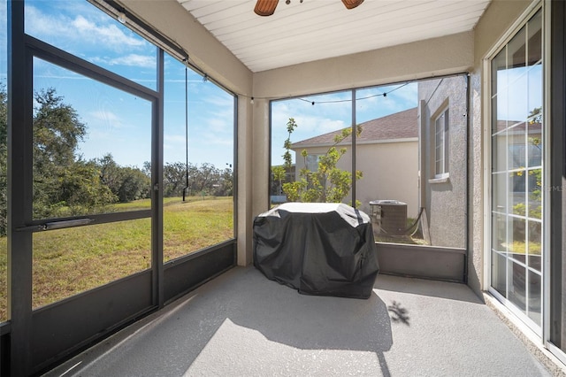 sunroom / solarium with a wealth of natural light and ceiling fan